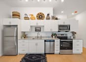 Thumbnail 13 of 24 - Kitchen with appliances and cabinets at The Freelon at Sugar Hill, Detroit, MI 48201