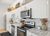 Thumbnail 14 of 24 - Kitchen with appliances and White cabinets  at The Freelon at Sugar Hill, Detroit, Michigan 48201