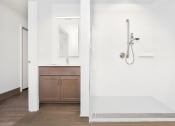 Thumbnail 1 of 10 - a white bathroom with a shower and a sink