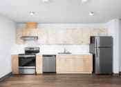 Thumbnail 2 of 18 - a kitchen with wooden cabinets and stainless steel appliances
