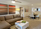 Thumbnail 11 of 44 - Spacious living room with woodburning fireplace and dining room area at Tanglewood Apartments in Lincoln Nebraska