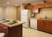 Thumbnail 19 of 27 - Apartments with upgraded kitchen, chestnut-colored cabinets, kitchen island, breakfast bar, lots of cabinet space, lots of counter space at Alpine Village Apartments in La Vista, Nebraska