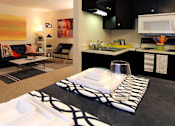 Thumbnail 1 of 27 - Apartments in central Omaha with spacious layout, spacious living room, and black kitchen cabinets at Kensington Woods Apartments in Omaha, Nebraska