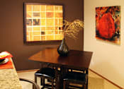 Thumbnail 33 of 35 - Spacious dining room with colored feature wall, and bright white kitchen with tile floor at LionsHead Apartments in Omaha, Nebraska