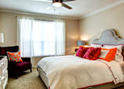 Thumbnail 11 of 36 - Spacious bedroom with walk-in closet and ceiling fan at Tuscany Apartments in Houston.