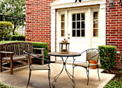 Thumbnail 13 of 34 - Private backyard patios and red brick exteriors at Tuscany Villas in Houston.