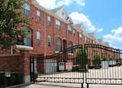 Thumbnail 28 of 34 - Luxury townhomes in a gated community with red brick exteriors and attached 2-car garages at Tuscany Row Townhomes in Houston.