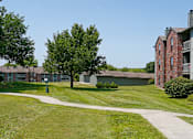 Thumbnail 27 of 35 - Green and red brick exterior, beautiful landscaping, scenic views, lots of trees, and spacious balconies at LionsHead Apartments in Omaha, Nebraska