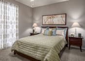 Thumbnail 41 of 42 - Spacious bedroom with walk-in closet and gray painted walls at Woodlake on the Bayou Apartments