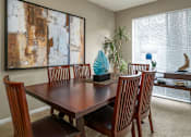 Thumbnail 20 of 42 - Spacious dining area with oversized windows, lots of natural light, and gray painted walls at Woodlake on the Bayou Apartments