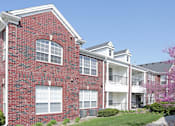Thumbnail 5 of 31 - Luxury apartments with red brick exteriors, beautiful landscaping, and scenic views at Rockledge Oaks Apartments in Lincoln, Nebraska