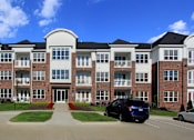 Thumbnail 24 of 46 - Luxury apartments in a gated community with brick exteriors and underground parking garage at Bellemeade Apartments in west Des Moines