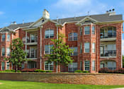 Thumbnail 28 of 36 - Luxury apartments with red brick exterior, spacious balconies, lush landscaping, and scenic views at Lenox Village Apartments in Lincoln, Nebraska