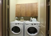 Thumbnail 41 of 42 - Luxury apartments with full size front loading washer and dryer with cabinet space above at Tuscany Walk Apartments in Houston.