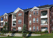 Thumbnail 19 of 31 - Luxury apartments with spacious balcony, red brick exterior, and beautiful landscaping at Rockledge Oaks Apartments in Lincoln, Nebraska