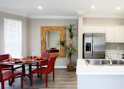 Thumbnail 28 of 31 - Luxury apartments with spacious u-shaped kitchen, white cabinets, oversized windows, spacious dining room, stainless steel appliances, and bright white kitchen at Rockledge Oaks Apartments in Lincoln, Nebraska