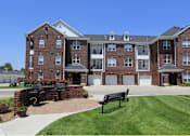 Thumbnail 29 of 31 - Luxury apartments with red brick exteriors, resident grilling station, and attached garages at Rockledge Oaks Apartments in Lincoln, Nebraska