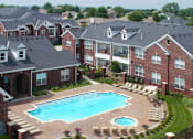 Thumbnail 27 of 31 - Luxury apartments with red brick exteriors, swimming pool, pool-side lounge chairs, beautiful landscaping, and scenic views at Rockledge Oaks Apartments in Lincoln, Nebraska