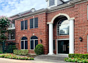Thumbnail 7 of 36 - Luxury apartments with brick exteriors and lush landscaping at Tuscany Apartments in Houston.