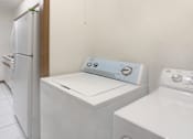 Thumbnail 24 of 25 - Apartments with full-size washer and dryer in unit, laundry room, bright white kitchen at LionsGate Apartments in Lincoln, Nebraska
