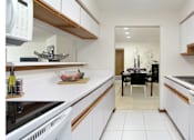 Thumbnail 7 of 25 - Bright white kitchen with lots of cabinet space, lots of counter space, and spacious dining room at at LionsGate Apartments in Lincoln, Nebraska
