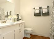 Thumbnail 10 of 19 - Spacious bright white bathroom with extra cabinet space at Plantation apartments near the Galleria in Houston.
