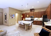 Thumbnail 17 of 42 - Luxury apartments with spacious kitchen and built-in wine rack, granite countertops, kitchen island, stainless steel appliances, and designer tile backsplash at Tuscany Walk Apartments in Houston Texas.