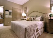 Thumbnail 21 of 42 - Master bedroom to accommodate a king-size bed and dresser with walk-in closet and master bathroom at Tuscany Apartments in Houston