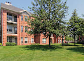 Thumbnail 33 of 36 - Luxury apartments with red brick exterior, lush landscaping, park-like setting, and scenic views at Lenox Village Apartments in Lincoln, Nebraska