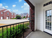 Thumbnail 12 of 31 - Luxury apartments with spacious balcony, red brick exterior, and beautiful landscaping at Rockledge Oaks Apartments in Lincoln, Nebraska