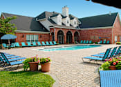 Thumbnail 3 of 36 - Luxury apartments with swimming pool, poolside lounge chairs, picnic area, grilling station, lush landscaping, and scenic views at Lenox Village Apartments in Lincoln, Nebraska