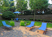 Thumbnail 16 of 36 - Luxury apartments with lush landscaping, picnic area, pool-side lounge chairs, park-like setting, and scenic views at Lenox Village Apartments in Lincoln, Nebraska