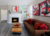 Thumbnail 1 of 31 - Luxury apartments with wood plank floors, gas fireplaces, built-in shelves, and gray wall color at Rockledge Oaks Apartments in Lincoln, Nebraska