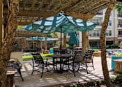 Thumbnail 13 of 37 - Luxury swimming pool with cabanas, poolside lounges, grilling stations, palm trees and beautiful landscaping at The Voss Apartments in Houston.