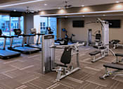 Thumbnail 16 of 42 - Luxury apartments with huge fitness center with multiple varieties of workout machines and equipment at Tuscany Walk Apartments in Houston Texas.