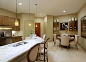 Thumbnail 31 of 42 - Spacious layout with built-in buffet with granite slab top in the dining room and 10-foot ceilings at Tuscany Walk Apartments in Houston Texas.