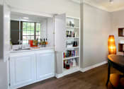 Thumbnail 10 of 36 - Luxury apartments with den, office space, wet bar, built-in shelves, and wood grain plank floors at Lenox Village Apartments in Lincoln, Nebraska