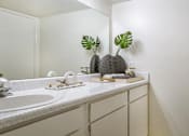 Thumbnail 9 of 38 - Spacious bright white bathroom with extra counter space at Woodlake Oaks Apartments in Houston