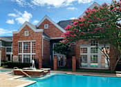 Thumbnail 16 of 36 - Luxury apartments with two resort-style swimming pools with fountain, poolside lounge chairs, and beautiful landscaping in Dallas.