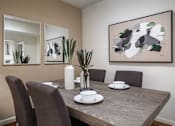Thumbnail 40 of 42 - Dining area with painted feature wall and wood plank floors at Woodlake on the Bayou Apartments
