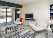Thumbnail 39 of 41 - Spacious living room with colored feature wall and built-in shelves at Embassy Park Apartments in Omaha, Nebraska