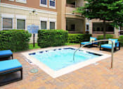 Thumbnail 25 of 36 - Luxury apartments with palm trees, spa, hot tub, spacious sundeck with poolside lounge chairs, beautiful landscaping, and fountains at Villa Piana Apartments in Dallas