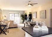 Thumbnail 11 of 41 - Apartments in central Omaha with open floor plan, open layout, condo-style layout, spacious living room, kitchen island, prep island, and colored feature wall at Embassy Park Apartments in Omaha, Nebraska