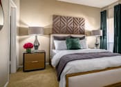 Thumbnail 6 of 38 - Spacious bedroom with walk-in closet and cozy grey wall color at Woodlake Oaks Apartments in Houston.