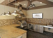 Thumbnail 16 of 36 - Luxury apartments with outdoor grilling station, granite bar top, and granite countertop at Villa Piana Apartments in Dallas