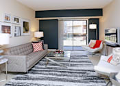 Thumbnail 23 of 41 - Spacious living room with colored feature wall at Embassy Park Apartments in Omaha, Nebraska