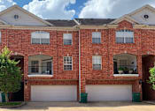 Thumbnail 16 of 34 - Luxury townhomes in a gated community with red brick exteriors and attached 2-car garages at Tuscany Row Townhomes in Houston.