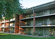 Thumbnail 15 of 27 - Apartments with brick exteriors, beautiful landscaping, lush landscaping, scenic views, large balconies, huge balconies, spacious balconies, and park-like setting with lots of trees at Alpine Village Apartments in La Vista, Nebraska