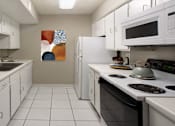 Thumbnail 9 of 10 - Bright white kitchen with gray wall color, white kitchen cabinets, lots of cabinet space, lots of counter space, and porcelain tile floors at The Inverness Apartments in La Vista, Nebraska
