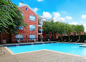 Thumbnail 33 of 50 - Luxury apartments with large swimming pool, multiple swimming pools, spa, and large sundeck with poolside lounge chairs at The Lanesborough Apartments in Houston